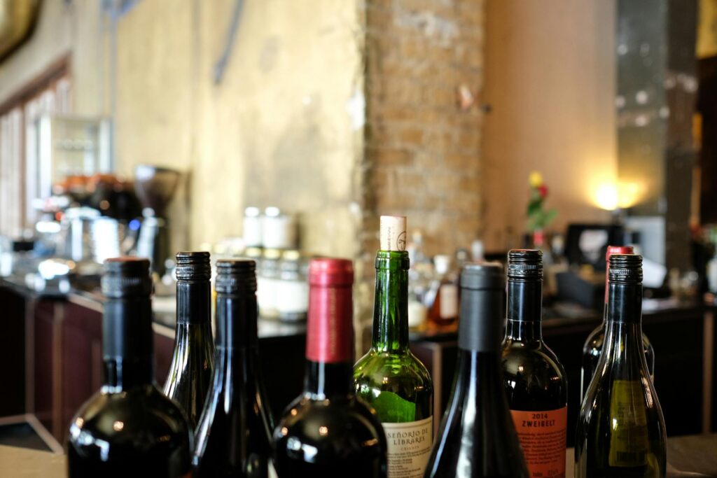 Detalle de las partes superiores de varias botellas de vino agrupadas sobre una mesa